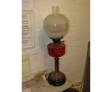 Duplex oil lamp converted to electricity (needs re-wiring), reeded brass column on black china base with ruby glass reservoir