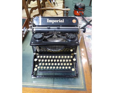 An Imperial 50 typewriter, glazed panels to sides, with original dust cover