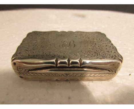 Silver snuff box of cushion rectangular form with pinched edges, monogrammed EB and engraved with decorative scrolls, gilt in