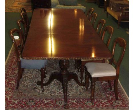 A fine reproduction William IV mahogany extending banqueting table with gadrooned fluted edge supported by two heavily carved