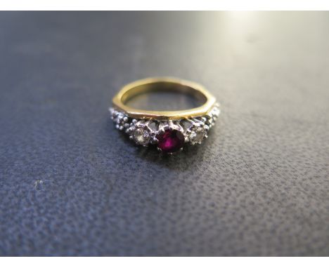 A hallmarked 18ct yellow gold ruby and diamond 3 Stone ring, size P, approx 4.6 grams, Ruby approx 5mm x 3mm, flanked by smal