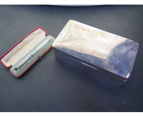 A silver desk cigarette case - 5cm x 16cm x 9cm and a white metal pencil/pen - dents to cigarette case, missing clip and push