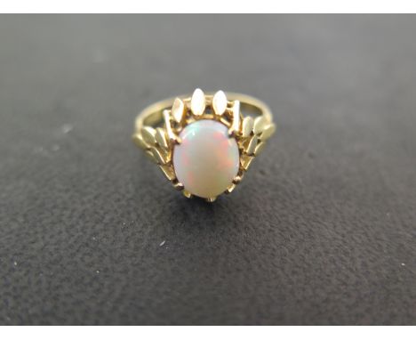 An 18ct gold dress ring, claw set with an oval cabochon, size M, approx 4 grams, hallmarked 18, opal approx 7mm x 9mm, some a