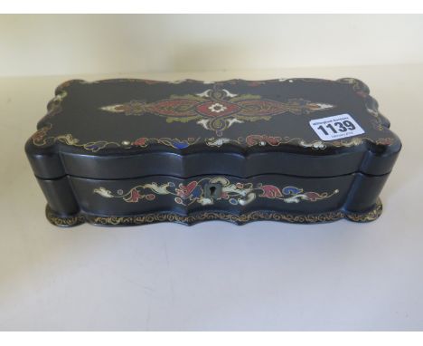 A papier mache box containing a collection of button hooks, some silver - Width 25cm x 7cm 