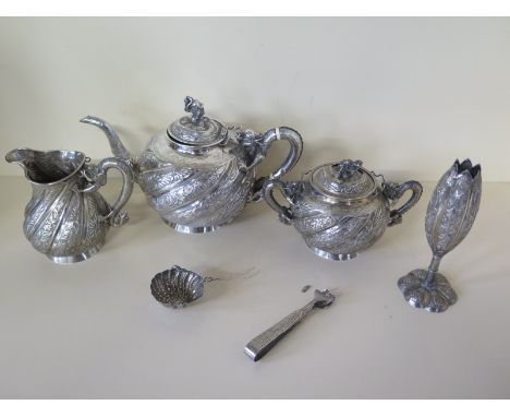 A Chinese silver tea set decorated with foliate and embossed dragons and dragon handles with dragon heads to lids - comprisin