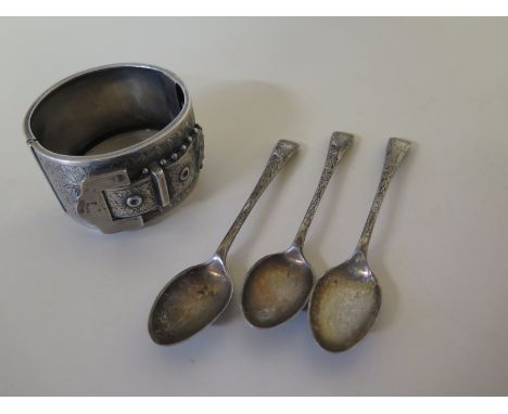 A silver bangle with repair and three silver teaspoons - approx weight 3 troy oz 