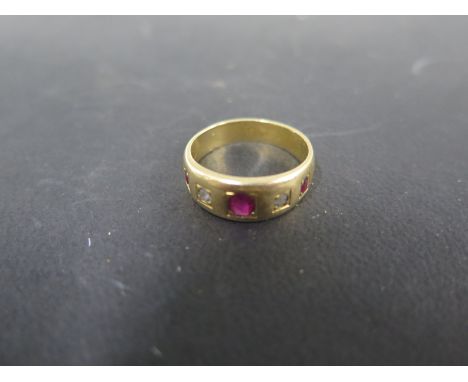 A yellow gold diamond and ruby ring size N/O - approx weight 6.3 grams - central ruby approx 4mm x 3mm - tests to approx 18ct