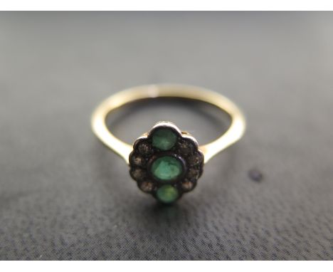 An 18ct Emerald and diamond ring size Q/R - approx weight 2.6 grams - light surface scratches, usage wear, otherwise good con