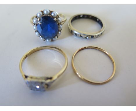 A 9ct yellow gold eternity ring size Q, a 9ct yellow gold pearl and blue stone dress ring size T, an 18ct yellow gold and dia