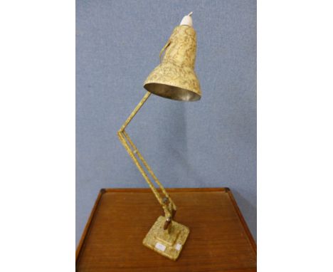 A mottled green anglepoise lamp