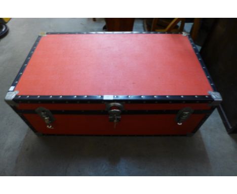 A red and black steamer trunk