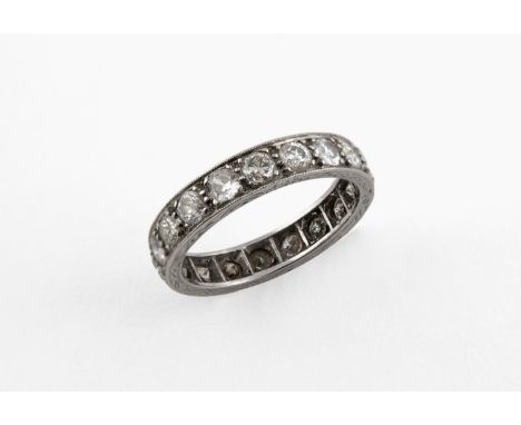 A DIAMOND FULL CIRCLE ETERNITY RING millegrain set with circular old-cut diamonds, in platinum. Size M