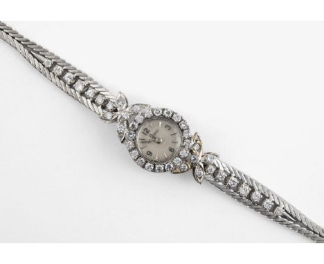 A LADY'S DIAMOND COCKTAIL WRISTWATCH BY JAEGER-Le-COULTRE the signed circular dial with Arabic quarters and dagger numerals, 