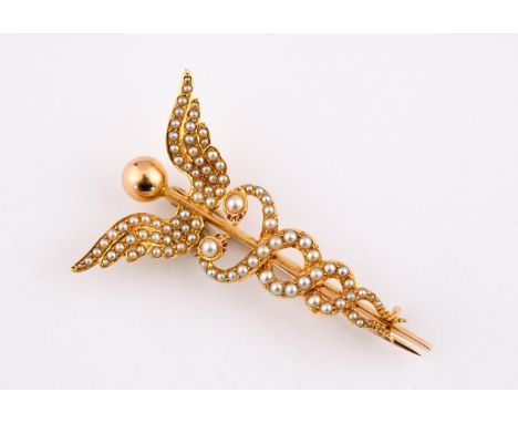 A GOLD AND PEARL SET WINGED SERPENT BROOCH mounted overall with graduated pearls, with cabochon ruby eyes, in gold, 5cm long