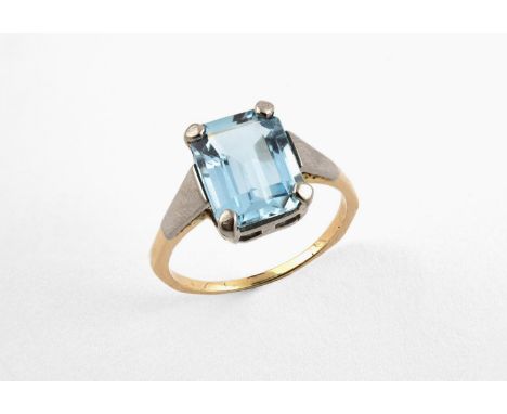 AN AQUAMARINE SINGLE STONE RING the step-cut aquamarine is set in gold. Size O 1/2