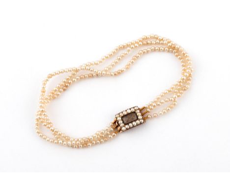 A VICTORIAN SEED PEARL BRACELET formed with three strands of seed pearls to a gold and seed pearl clasp, the centre section c