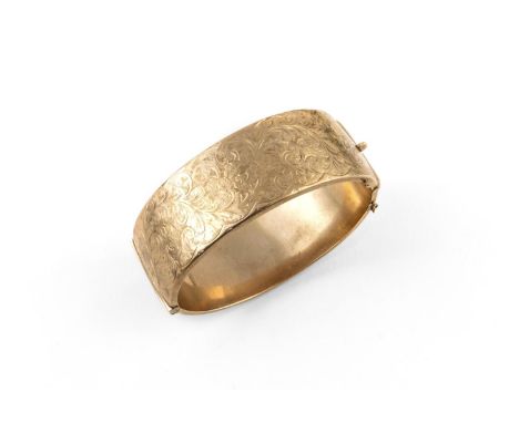 A 9CT GOLD HALF HINGED BANGLE set to one side with engraved foliate decoration, 27.6 grams, internal measurements 5.0 x 5.7cm