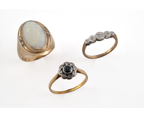 AN OPAL AND DIAMOND RING the oval-shaped solid white opal is set with three circular-cut diamonds to each shoulder, in yellow