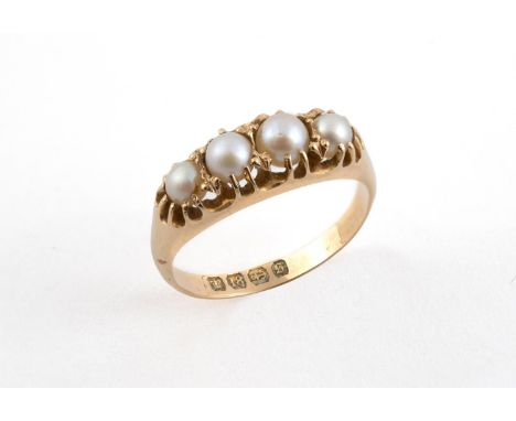 A PEARL AND GOLD RING mounted with four untested pearls in 18ct yellow gold. Size Q 1/2