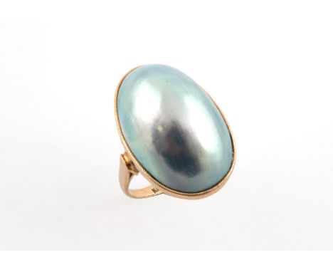 A MABE PEARL SINGLE STONE RING the oval-shaped mabe pearl is set in 18ct gold. Size M 1/2