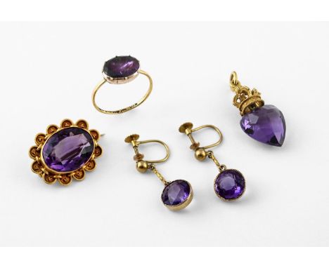 AN AMETHYST AND GOLD PENDANT the heart-shaped amethyst with gold crown surmount set with gem stones, 3cm long, together with 