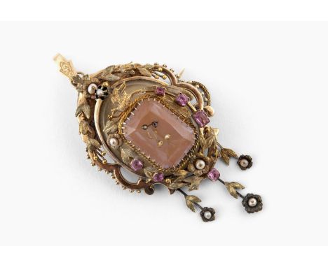 A GOLD AND PASTE SET MOURNING BROOCH PENDANT with foliate decoration, the centre section slides to reveal a portrait of a wom