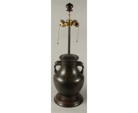 A CHINESE BRONZE TWIN HANDLE VASE CONVERTED TO A LAMP, mounted to a hardwood base, 70cm high overall.