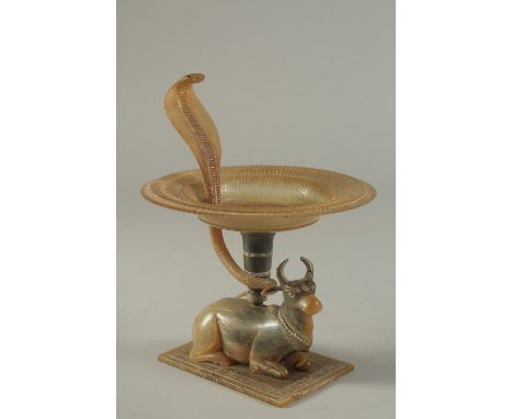 A FINE 19TH CENTURY INDIAN CARVED HORN OFFERING DISH, with a Nandi bull base, lotus shape dish with cobra finial, 21cm high.