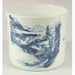 A CHINESE BLUE AND WHITE PORCELAIN BRUSH POT, painted with landscape scene and calligraphy, the base
