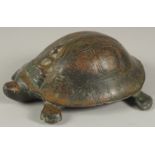 A CHINESE BRONZE BUDDHISTIC TURTLE, the shell bearing a seated Buddha, the base with inscriptions,