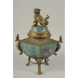 A CHINESE ENAMELLED BRASS TRIPOD CENSER AND COVER, with lion dog finial and twin dragon handles, the