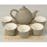 A JAPANESE SPECKLE-GLAZED CERAMIC TEA SET; comprising a teapot and five cups, (6).