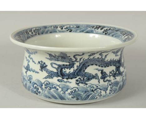 A CHINESE BLUE AND WHITE PORCELAIN DRAGON WATER BASIN, finely decorated with dragons amongst stylised clouds above a band of 