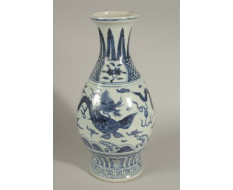 A CHINESE BLUE AND WHITE PORCELAIN DRAGON VASE, designed with two dragons chasing the flaming pearl of wisdom above waves, 34