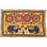 AN UZBEK SUZANI EMBROIDERED TEXTILE, with vibrant polychrome decoration of peacocks and blossoming