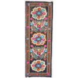 AN UZBEK SUZANI EMBROIDERED TEXTILE, with polychrome decorative floral roundels and birds, 228cm x