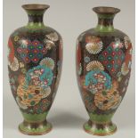 A PAIR OF JAPANESE BLACK GROUND CLOISONNE VASES, with floral roundels and other decorative motifs,