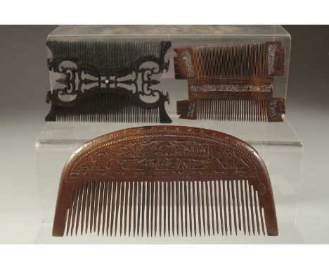 A FINELY CARVEEDD LARGE 19TH CENTURY PERSIAN QAJAR WOODEN COMB, with calligraphy, together with another two possibly Indian c