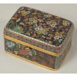 A FINE JAPANESE MEIJI PERIOD BLACK GROUND CLOISONNE BOX, with floral decoration and hinged lid, 5.