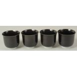 A SET OF FOUR BLACK GLAZE SAKE CUPS, 8cm high, 9cm diameter, in original fitted box.