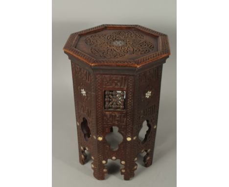 A MOORISH MOTHER OF PEARL INLAID CARVED WOOD HEXAGONAL TABLE, 47cm high.