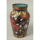 A CHINESE BLACK GROUND CLOISONNE VASE, decorated with birds and flora, (af), 24cm high.