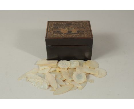 A COLLECTION OF CHINESE ETCHED MOTHER OF PEARL GAMING COUNTERS IN A GILT AND BLACK LACQUER BOX, the pieces of various shapes,