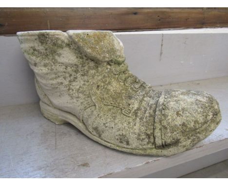 A concrete garden shoe planter