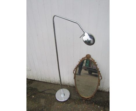 Ornate gilt framed wall mirror and chrome floor lamp