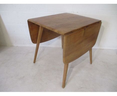 A blonde Ercol drop leaf table