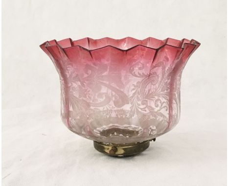 A turn of the century cranberry glass oil lamp shade