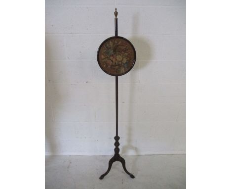 A Victorian pole screen on tripod base with claw and ball feet
