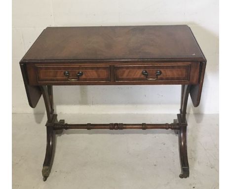 A reproduction sofa table in the Regency style