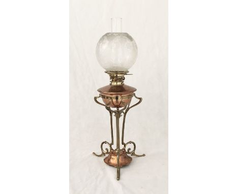 An Arts and Crafts copper and brass oil lamp, in the manner of W A S Benson, circa 1900, with a frosted glass shade, on a sty